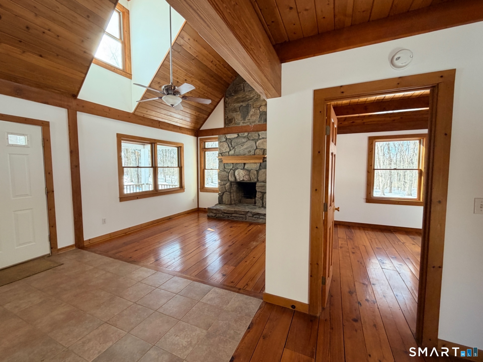 249 Woodbury Road Washington, CT 06793 - Photo 6 of 23 a view of a livingroom with wooden floor and a kitchen