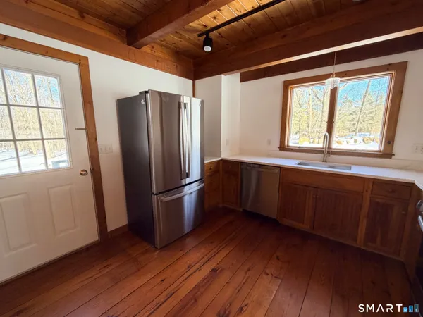 a kitchen with wooden floors and a sink