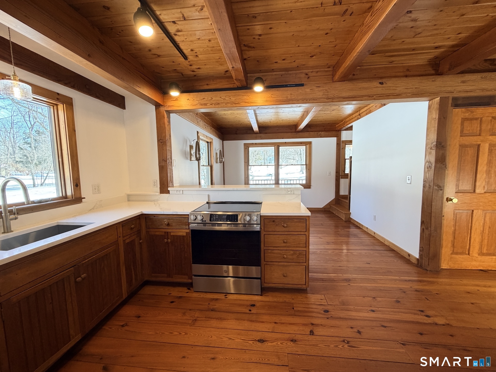 249 Woodbury Road Washington, CT 06793 - Photo 10 of 23 a kitchen with wooden floors and a sink