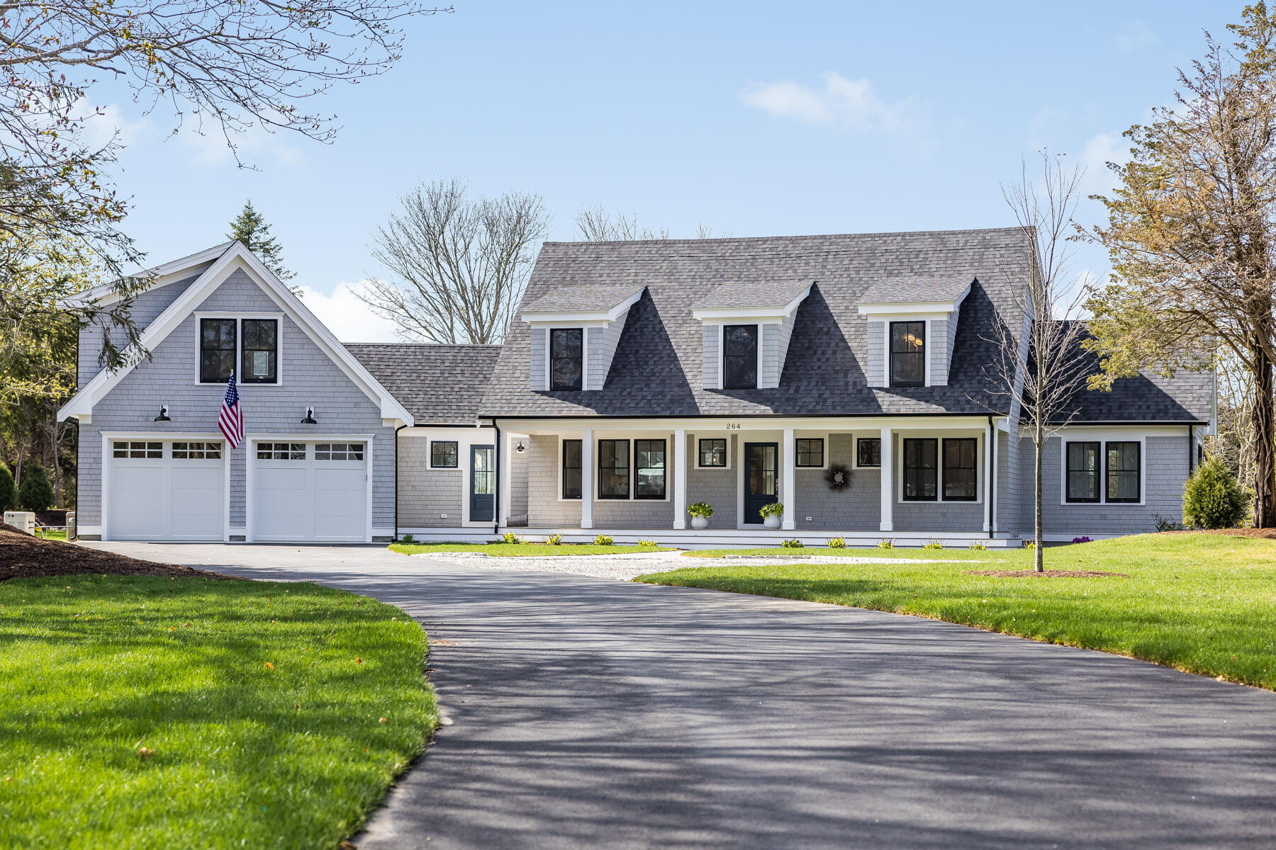264 Tonset Road Orleans, MA 02653 - Photo 2 of 92 a front view of a house with a yard and palm trees