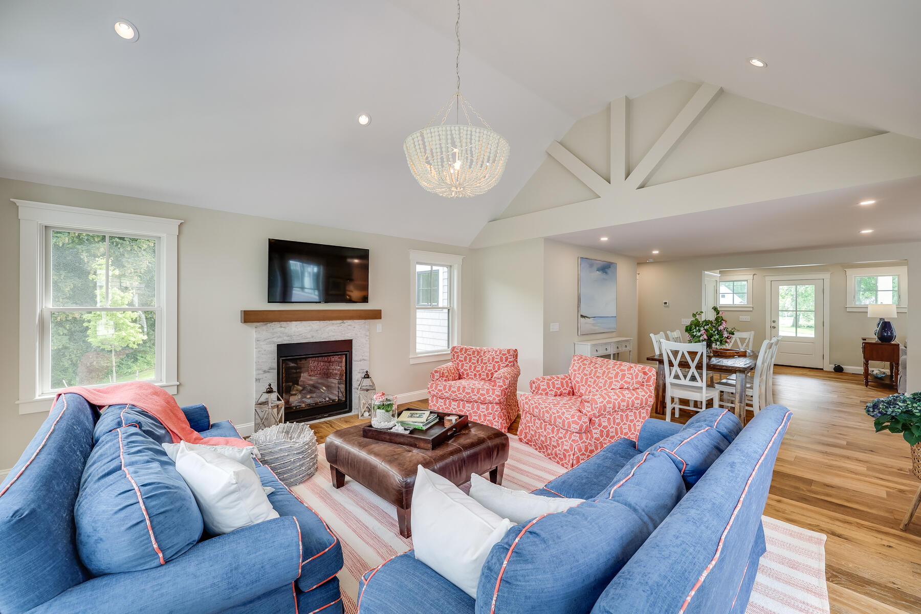 264 Tonset Road Orleans, MA 02653 - Photo 36 of 92 a living room with furniture a fireplace and a flat screen tv