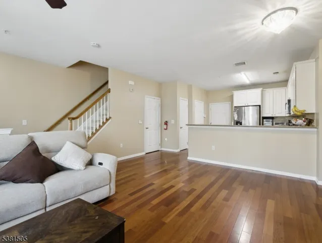 a living room with furniture and kitchen view