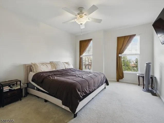 a spacious bedroom with a bed and a chandelier