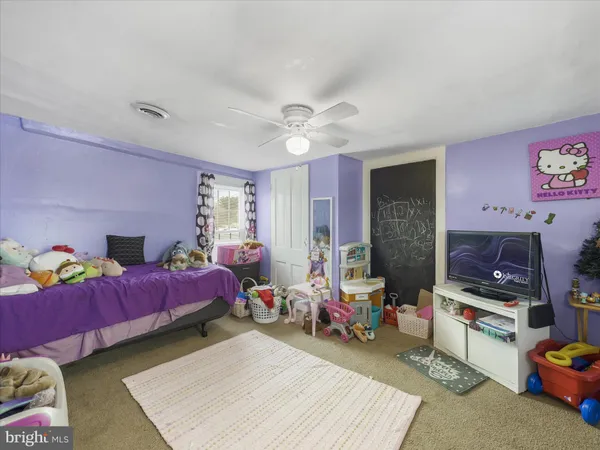 a bedroom with furniture and a window