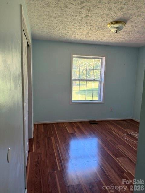 4084 Carpenters Cove Road Claremont, NC 28610 - Photo 18 of 27 a view of an empty room with wooden floor and a window