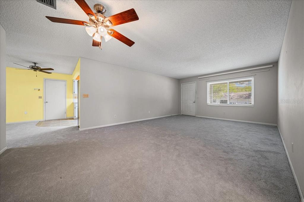 8702 Southwest 94 Street, Unit A Ocala, FL 34481 - Photo 12 of 55 an empty room with a window and a ceiling fan