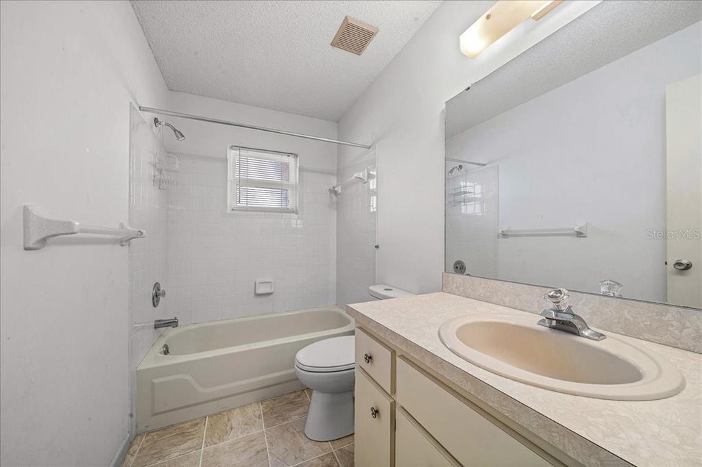 8702 Southwest 94 Street, Unit A Ocala, FL 34481 - Photo 15 of 55 a bathroom with a sink toilet and shower