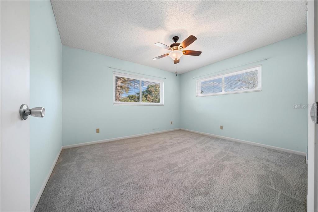 8702 Southwest 94 Street, Unit A Ocala, FL 34481 - Photo 18 of 55 a view of an empty room with a fan