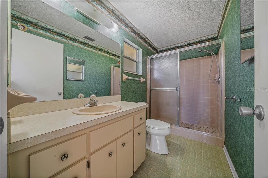 8702 Southwest 94 Street, Unit A Ocala, FL 34481 - Photo 23 of 55 a bathroom with a sink toilet and shower