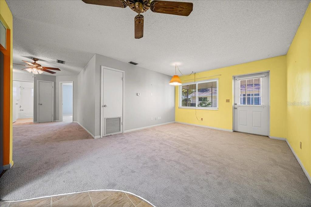 8702 Southwest 94 Street, Unit A Ocala, FL 34481 - Photo 27 of 55 a view of an empty room with a fireplace and a window