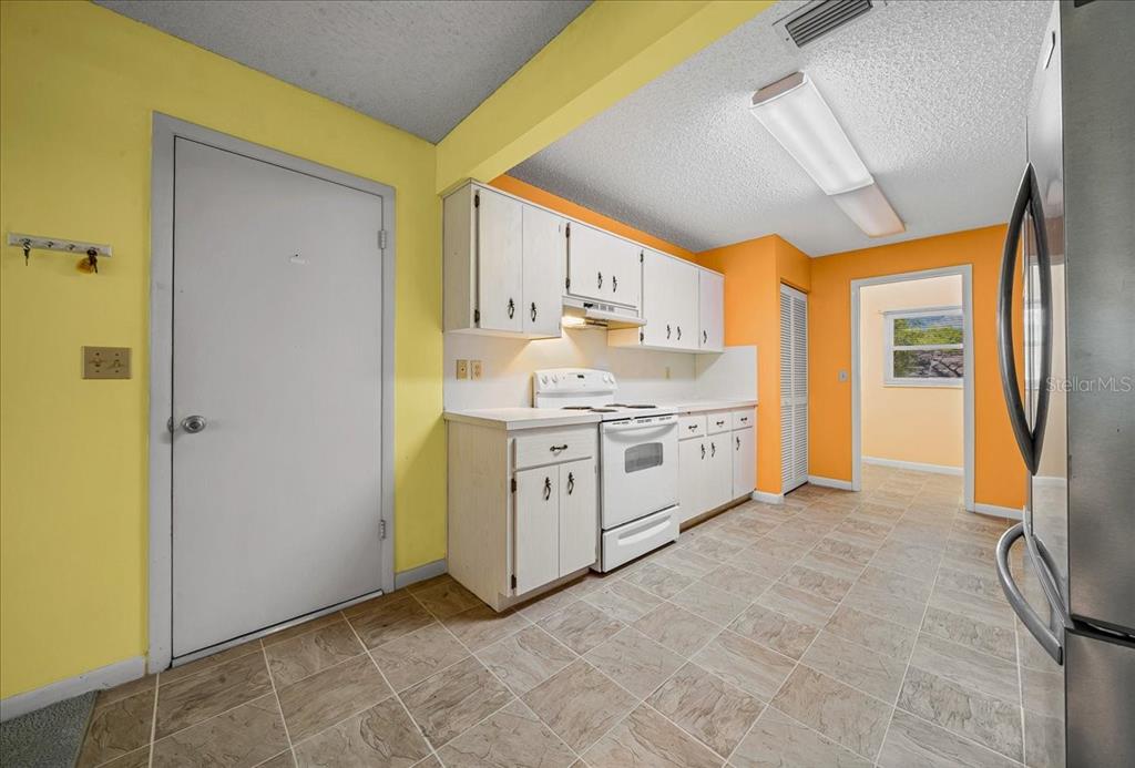 8702 Southwest 94 Street, Unit A Ocala, FL 34481 - Photo 29 of 55 a utility room with cabinets washer and dryer