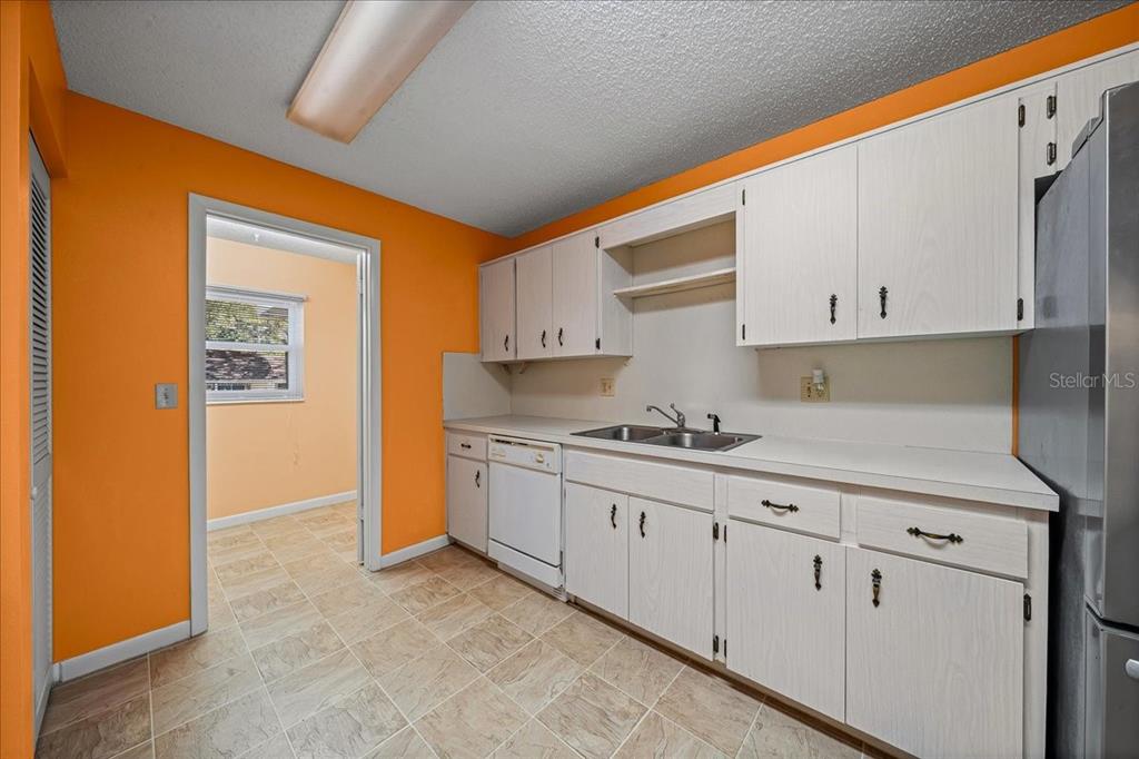 8702 Southwest 94 Street, Unit A Ocala, FL 34481 - Photo 31 of 55 a kitchen with granite countertop white cabinets and stainless steel appliances
