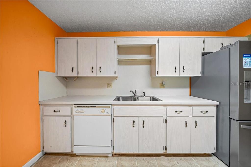 8702 Southwest 94 Street, Unit A Ocala, FL 34481 - Photo 32 of 55 a kitchen with white cabinets