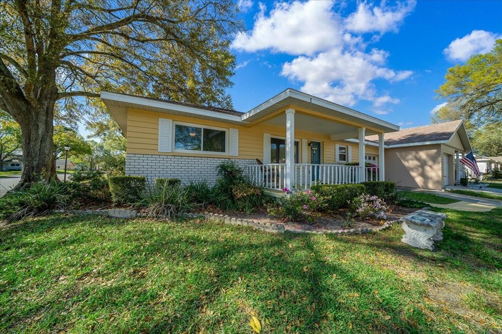 8702 Southwest 94 Street, Unit A Ocala, FL 34481 - Photo 43 of 55 a front view of a house with a garden