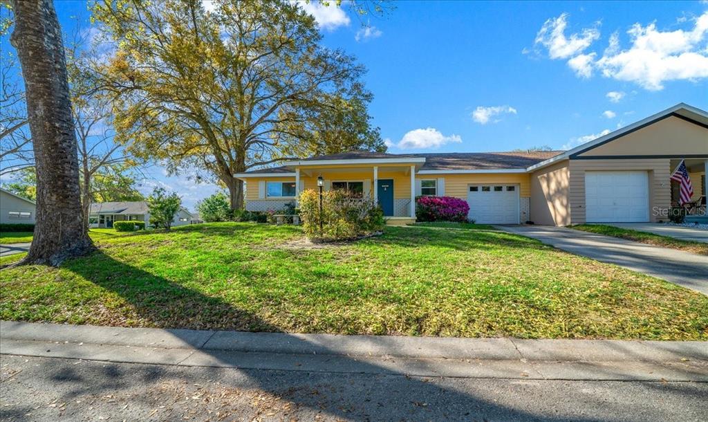 8702 Southwest 94 Street, Unit A Ocala, FL 34481 - Photo 45 of 55 a front view of house with yard and green space