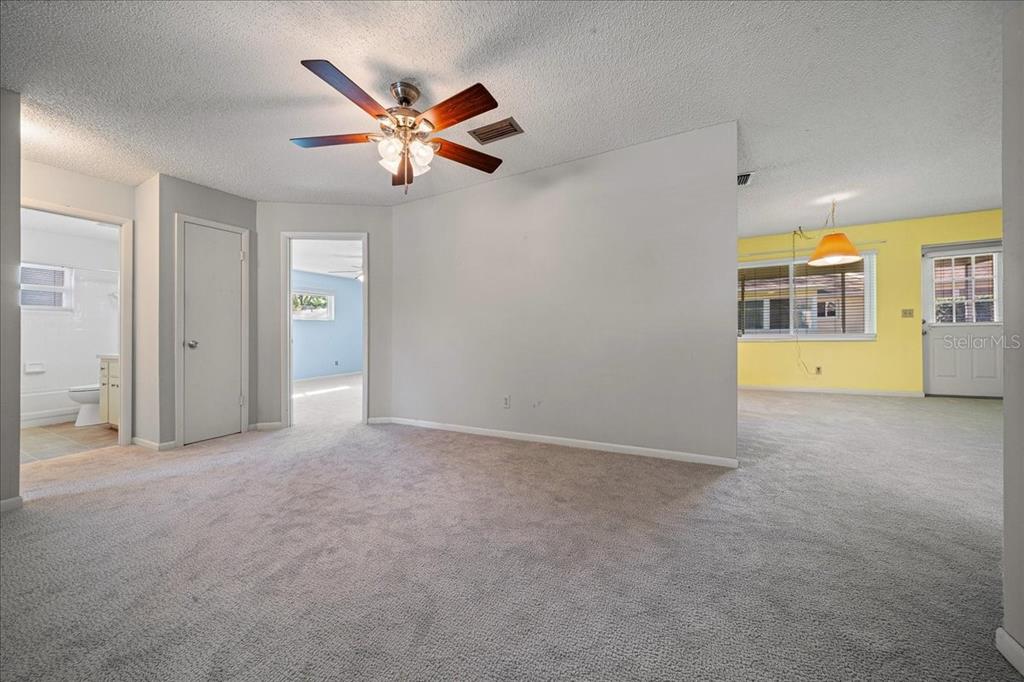 8702 Southwest 94 Street, Unit A Ocala, FL 34481 - Photo 9 of 55 a view of a livingroom with a ceiling fan and window