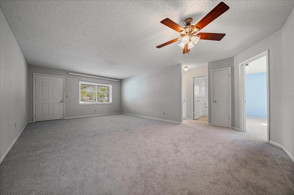 8702 Southwest 94 Street, Unit A Ocala, FL 34481 - Photo 10 of 55 an empty room with closet and ceiling fan