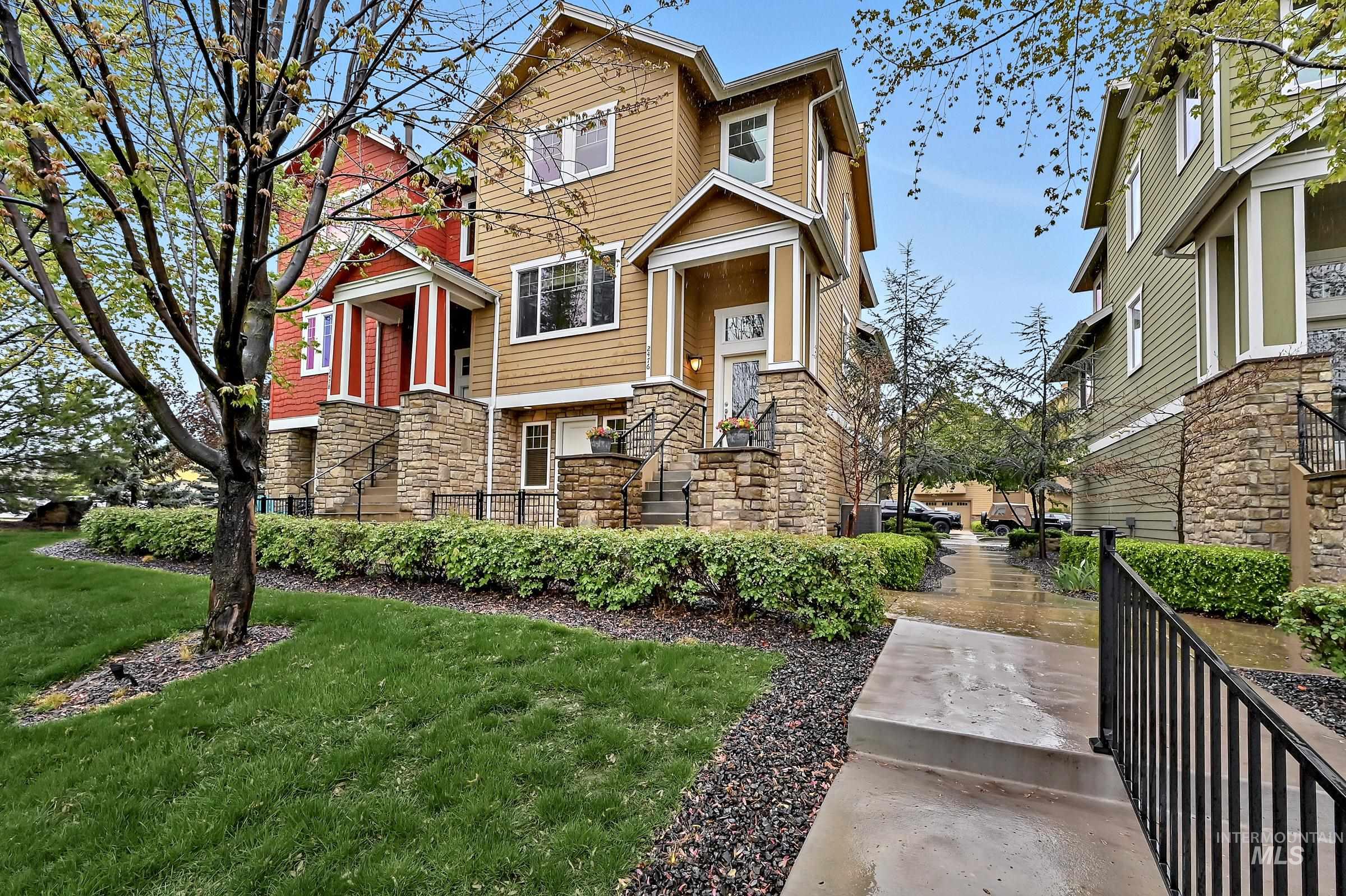 Front exterior with brick façade, arched entry, and landscaped walkway. Well-kept curb appeal with mature greenery.