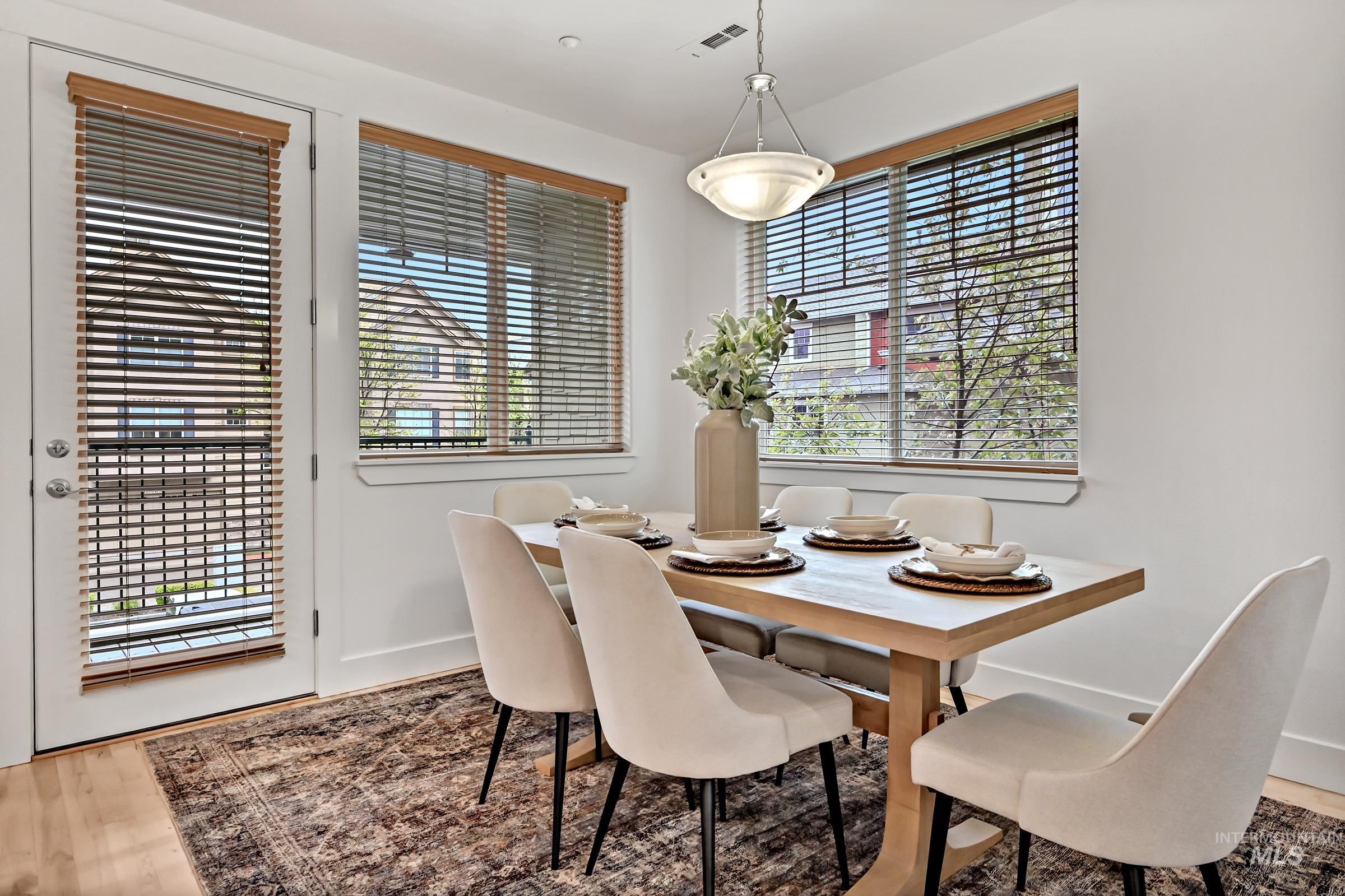 2476 North Bogus Basin Road Boise, ID 83702 - Photo 12 of 48 Dining area with large windows and access to covered outdoor space. Bright setting with hardwood floors.
