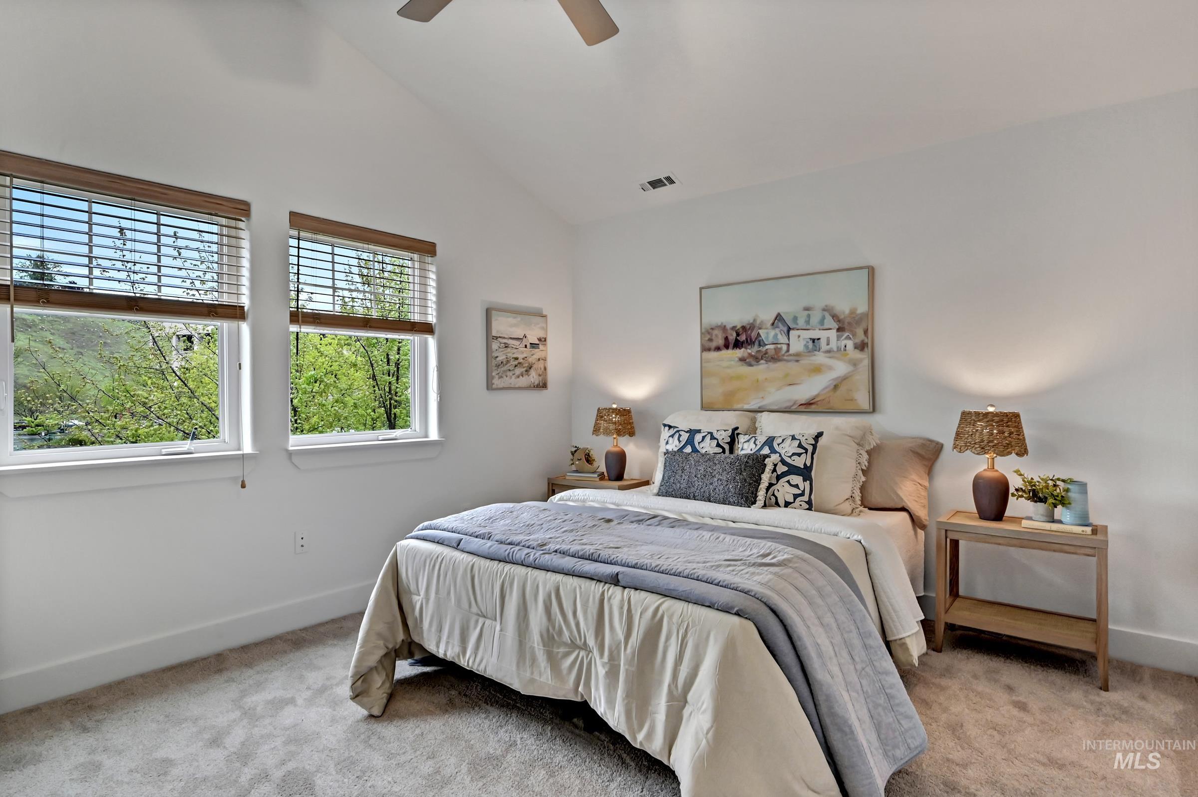 2476 North Bogus Basin Road Boise, ID 83702 - Photo 24 of 48 Ensuite bedroom with large window and carpeting. Bright space with neutral finishes.