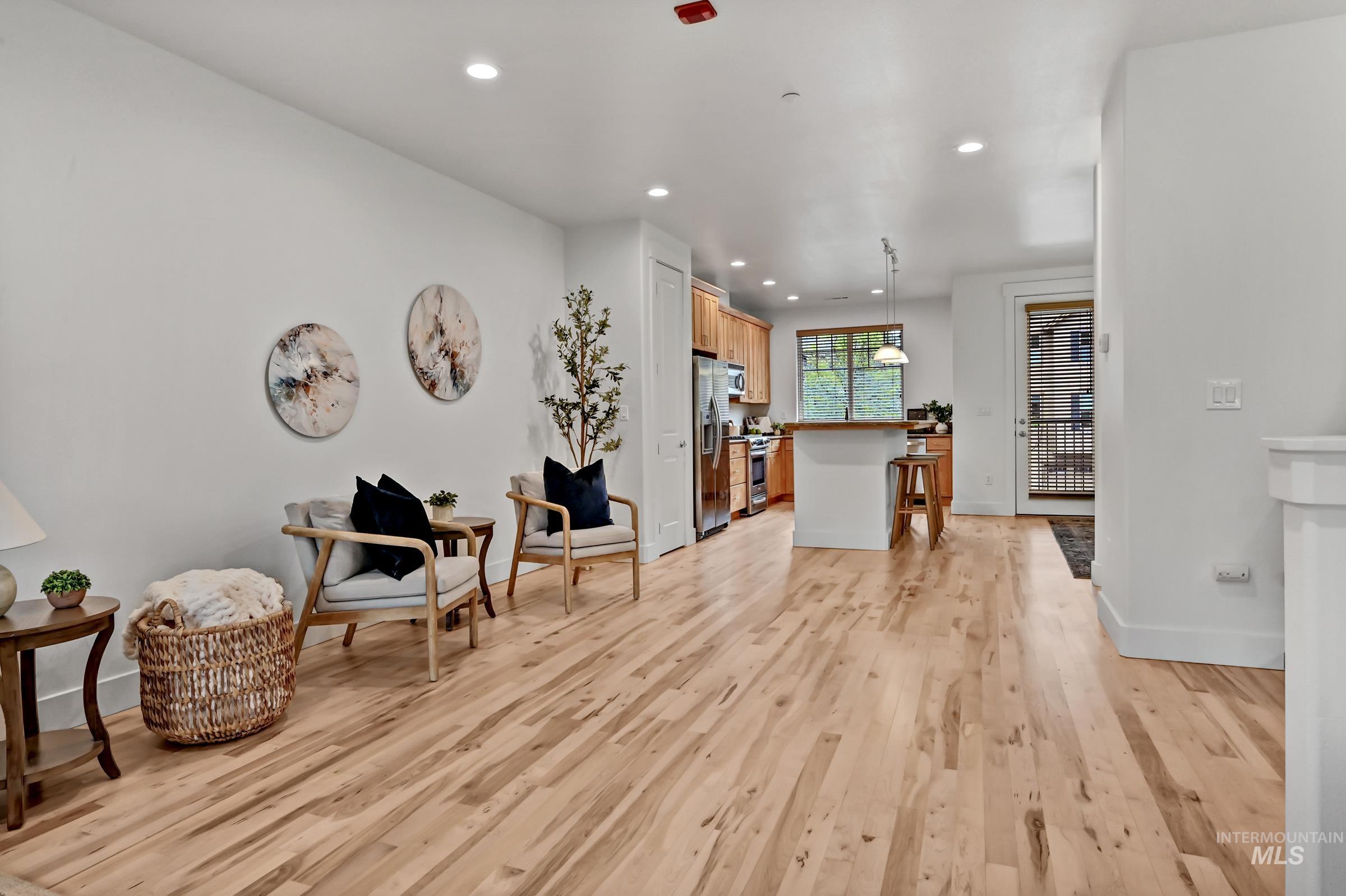 2476 North Bogus Basin Road Boise, ID 83702 - Photo 6 of 48 Living area with hardwood floors and open flow to kitchen and dining area. Bright, functional layout for everyday use.