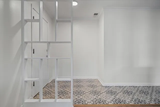 a view of empty room with wooden floor and window