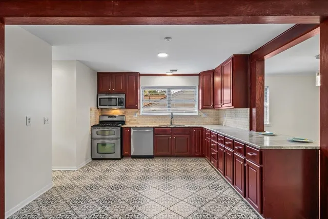 a view of a kitchen with a sink and a fireplace
