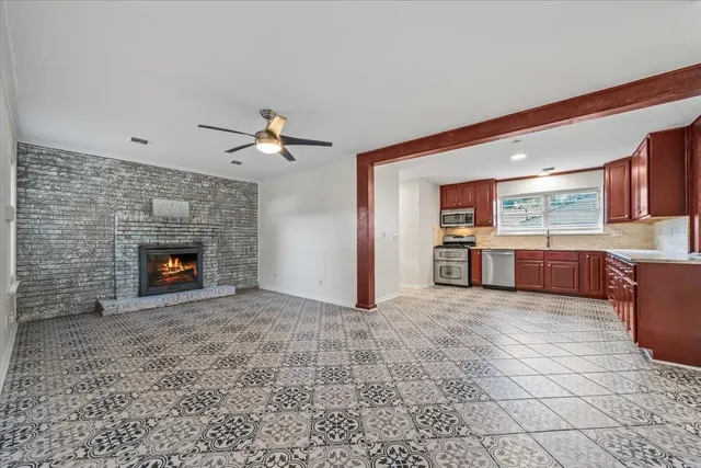 wooden floor in an empty room with a fireplace