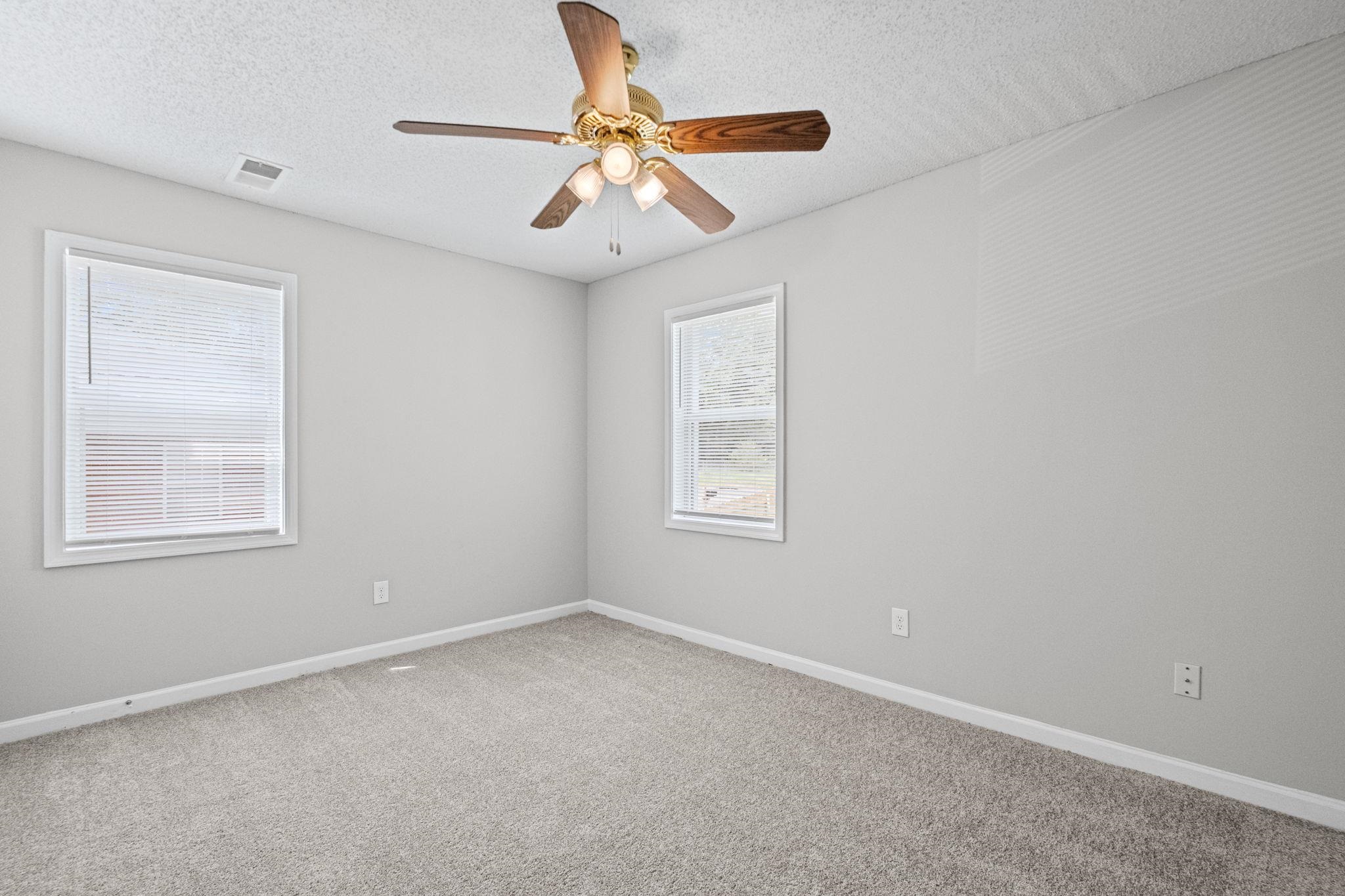 3580 Ramill Road Memphis, TN 38128 - Photo 11 of 24 Spare room featuring ceiling fan, light colored carpet, and a textured ceiling