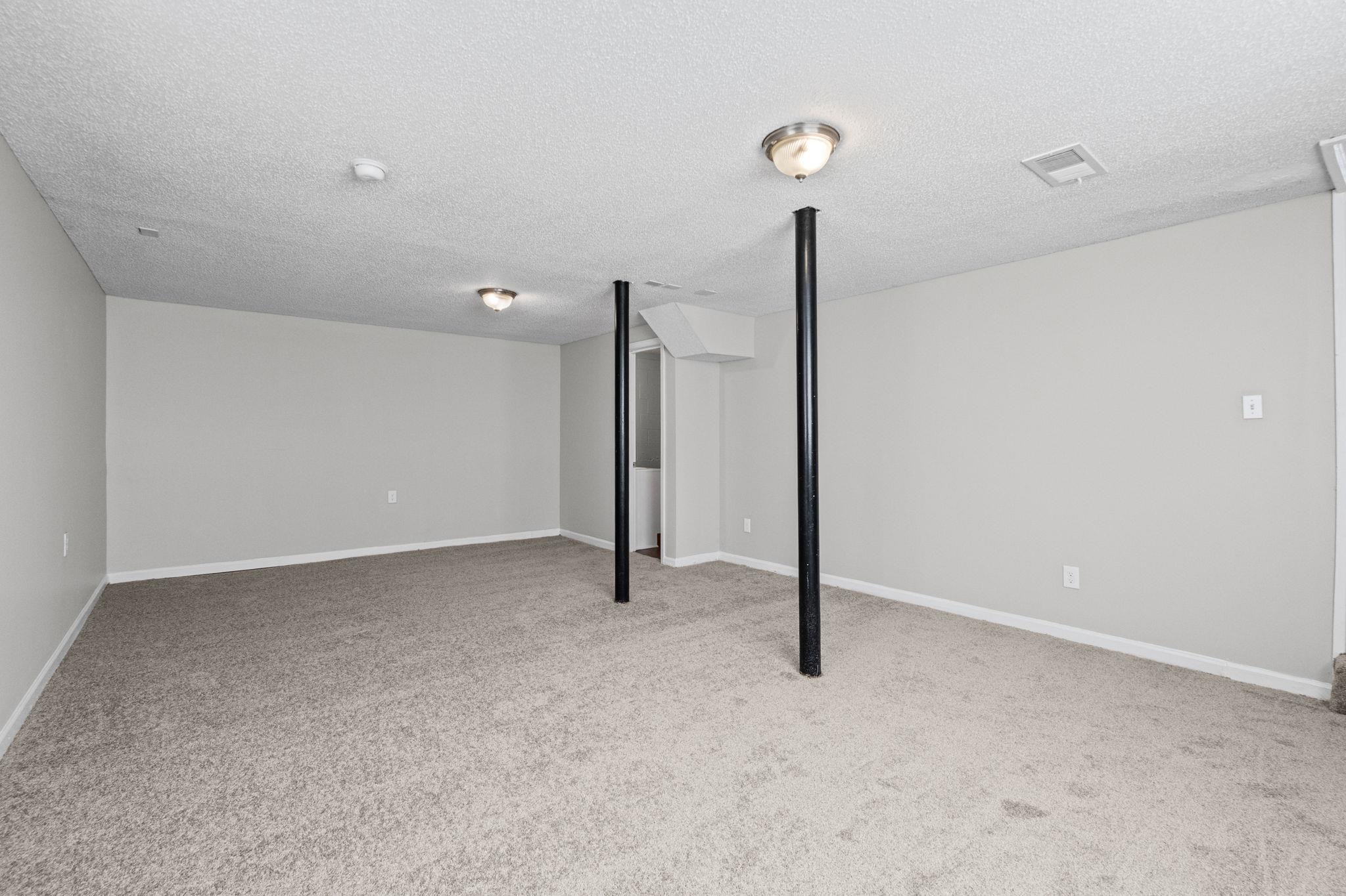 3580 Ramill Road Memphis, TN 38128 - Photo 16 of 24 Finished below grade area featuring light colored carpet and a textured ceiling