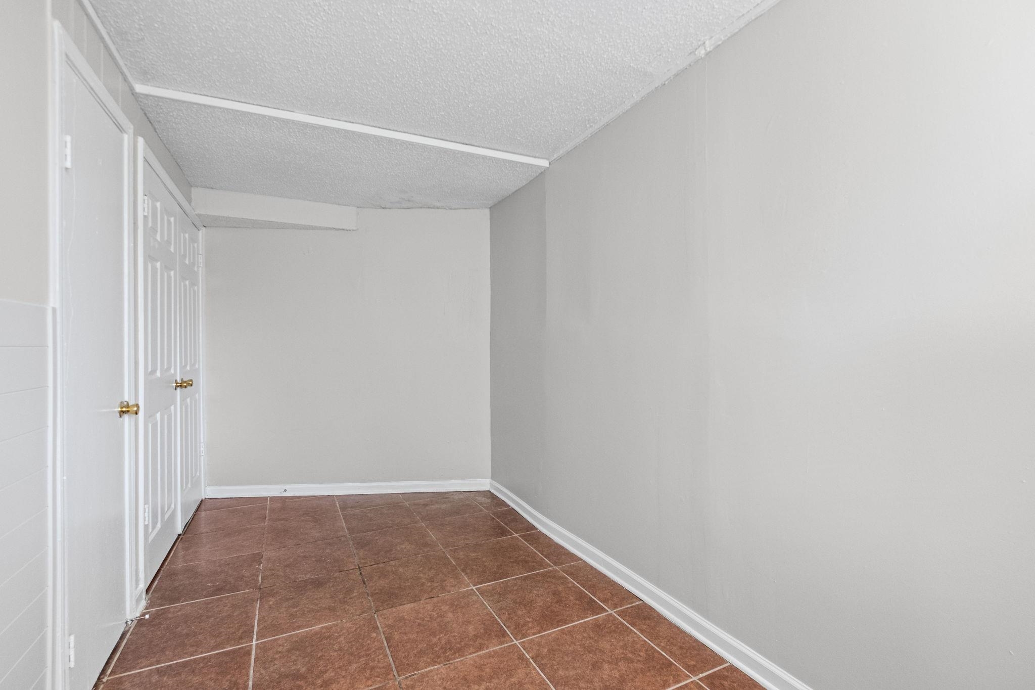 3580 Ramill Road Memphis, TN 38128 - Photo 18 of 24 Hall featuring a textured ceiling and dark tile patterned flooring