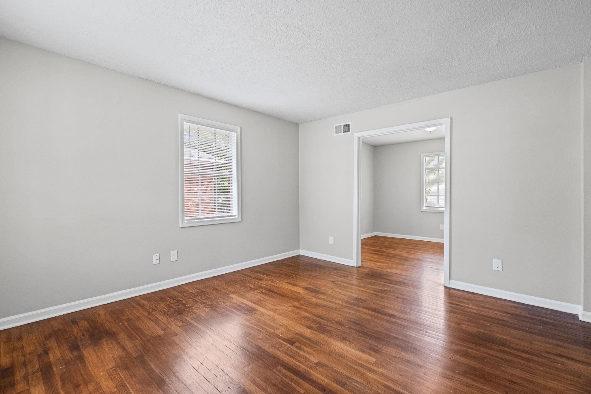 3580 Ramill Road Memphis, TN 38128 - Photo 4 of 24 Unfurnished room featuring dark wood-style flooring and a textured ceiling