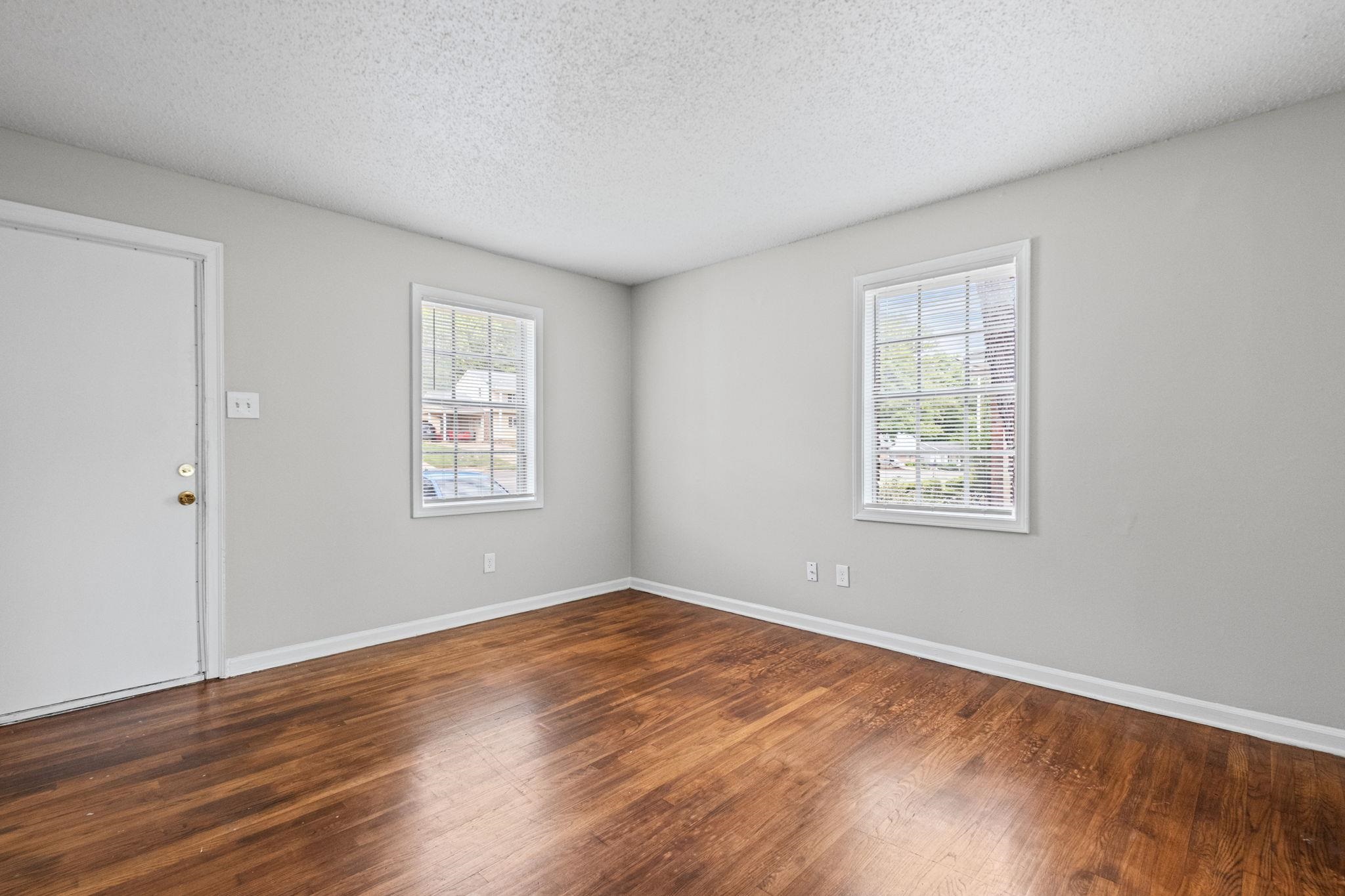 3580 Ramill Road Memphis, TN 38128 - Photo 5 of 24 Unfurnished room featuring dark wood-type flooring and a textured ceiling