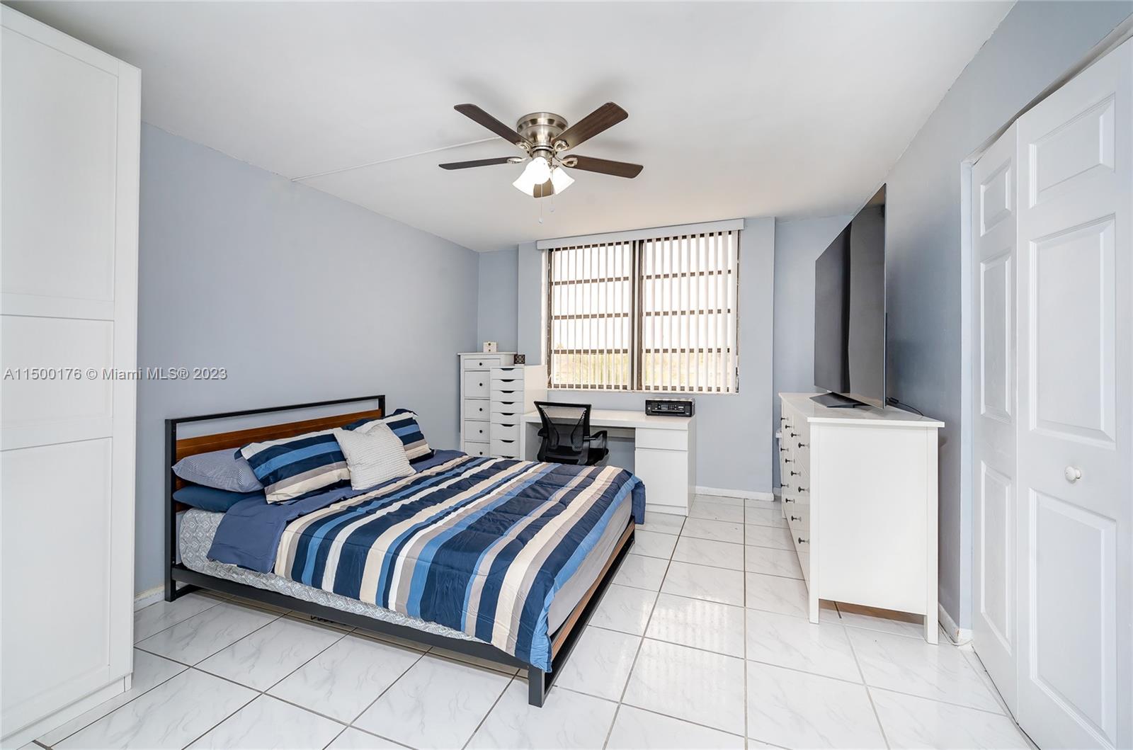 12239 Southwest 14th Lane, Unit 3401 Miami, FL 33184 - Photo 12 of 23 a bedroom with a bed and a window