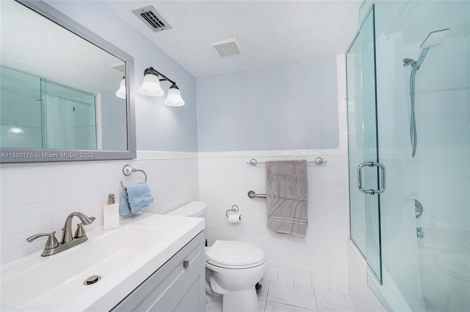 12239 Southwest 14th Lane, Unit 3401 Miami, FL 33184 - Photo 13 of 23 a bathroom with a sink toilet and shower