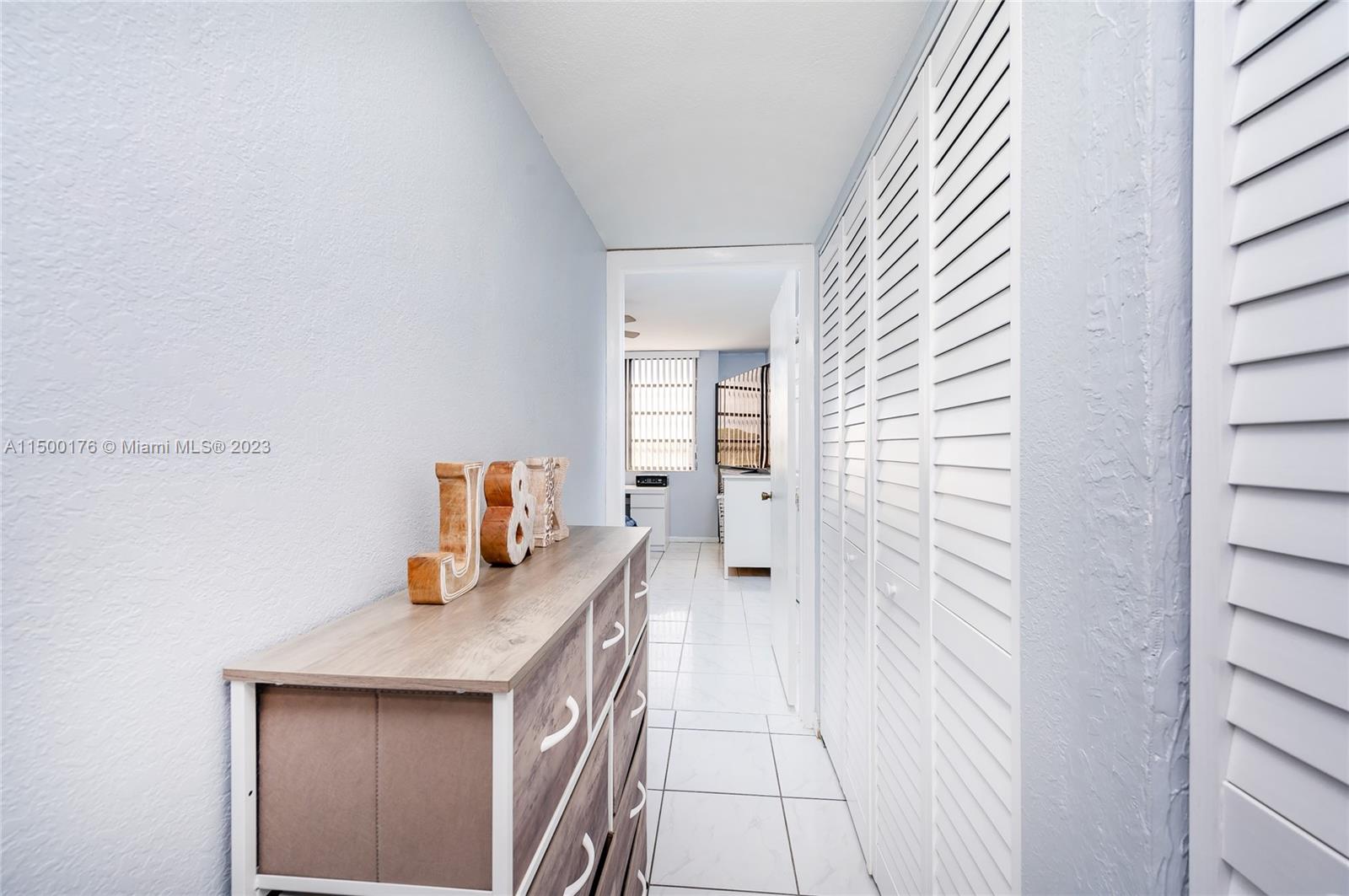 12239 Southwest 14th Lane, Unit 3401 Miami, FL 33184 - Photo 15 of 23 a bathroom with a sink and a mirror