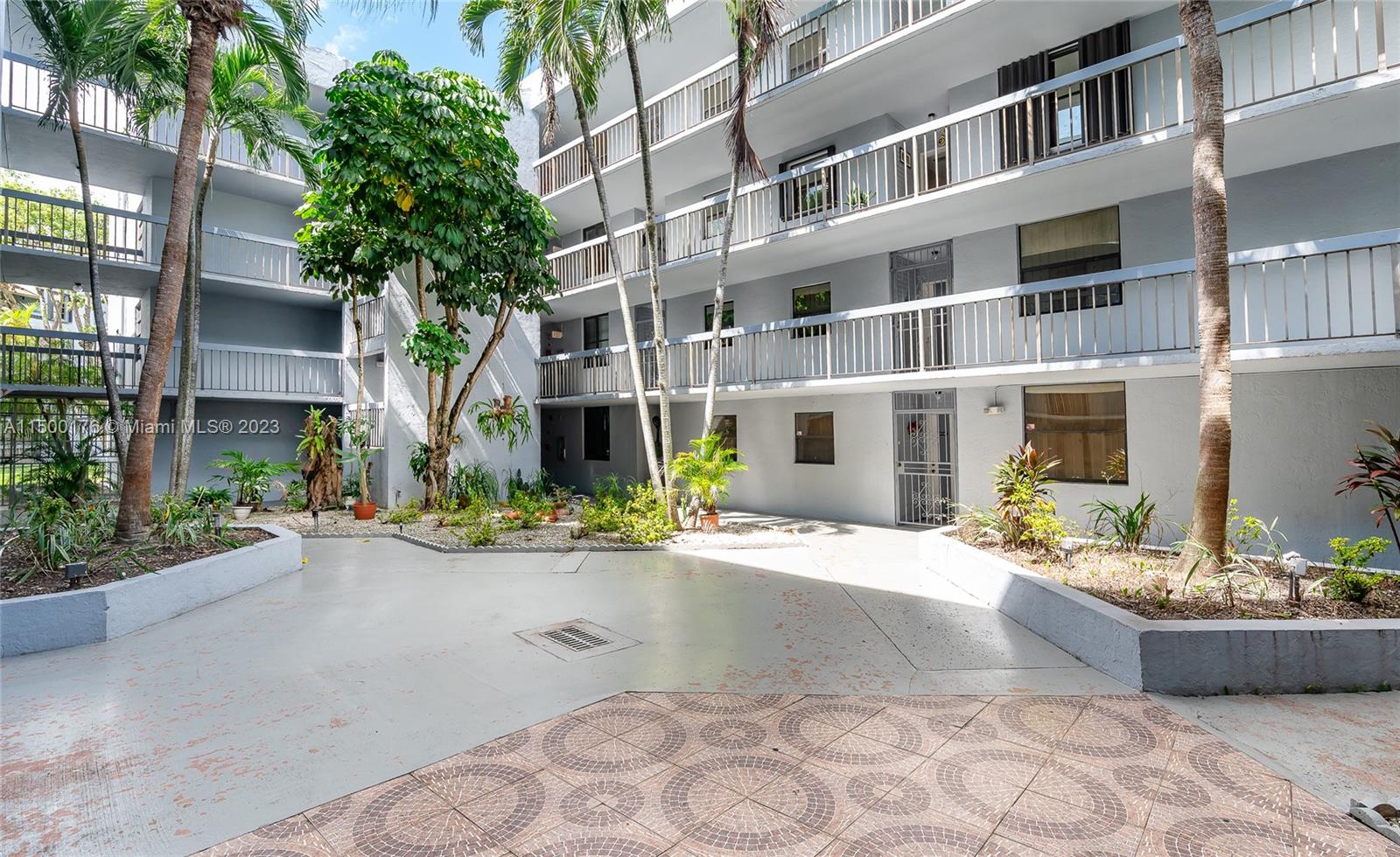 12239 Southwest 14th Lane, Unit 3401 Miami, FL 33184 - Photo 20 of 23 a front view of a building with a garden and plants
