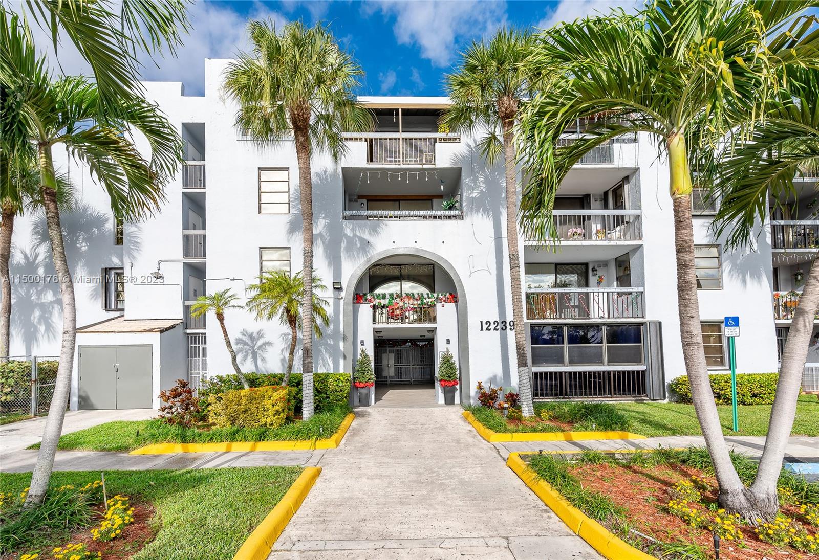 12239 Southwest 14th Lane, Unit 3401 Miami, FL 33184 - Photo 2 of 23 a front view of a house with a garden and plants