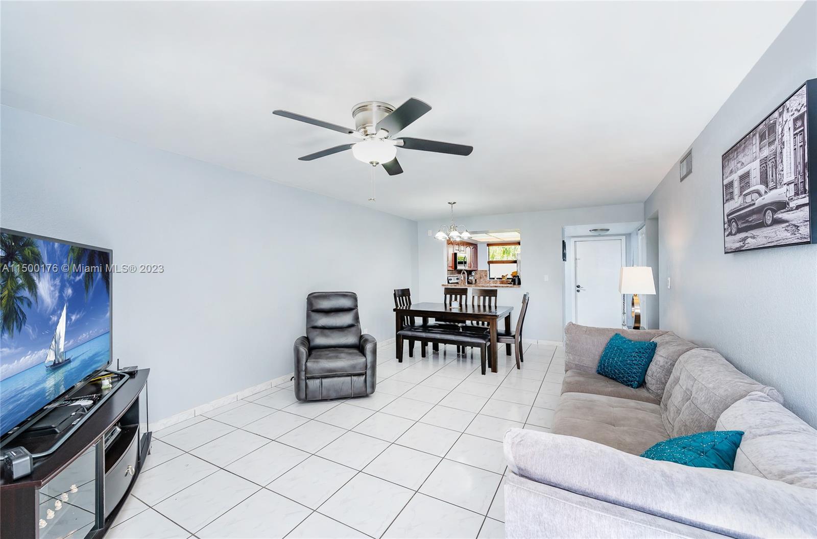 12239 Southwest 14th Lane, Unit 3401 Miami, FL 33184 - Photo 3 of 23 a living room with furniture and a flat screen tv