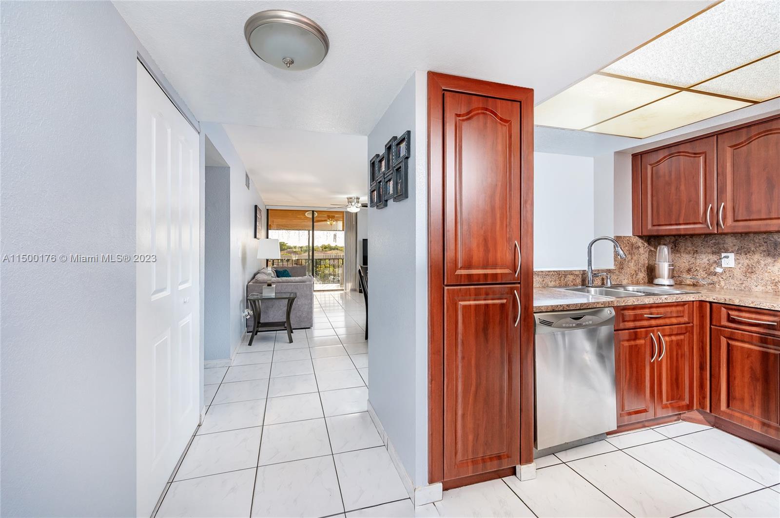 12239 Southwest 14th Lane, Unit 3401 Miami, FL 33184 - Photo 9 of 23 a kitchen with stainless steel appliances granite countertop a refrigerator and a sink