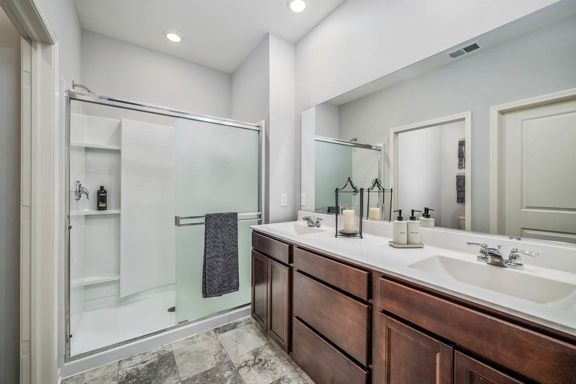 890 Eineke Boulevard Algonquin, IL 60102 - Photo 18 of 27 a bathroom with a shower sink and mirror
