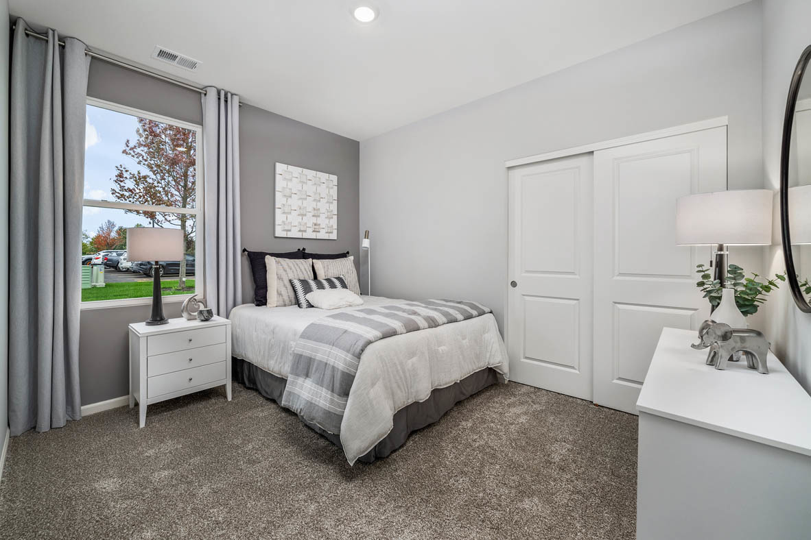 890 Eineke Boulevard Algonquin, IL 60102 - Photo 4 of 27 a bedroom with a bed and a table in it