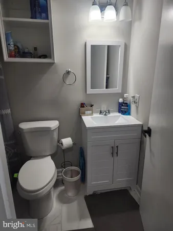 a white toilet sitting next to a bathroom sink