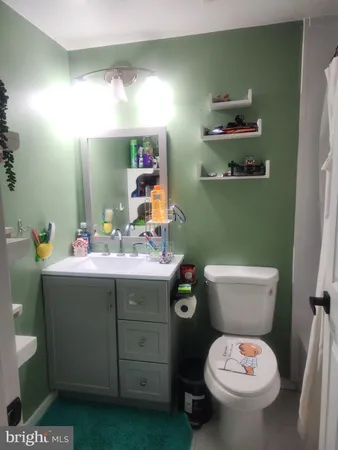 a bathroom with a toilet sink and mirror