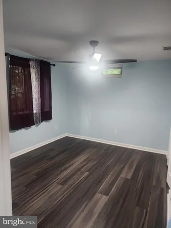 a view of an empty room and wooden floor