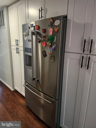 a view of a refrigerator in kitchen and wooden floor