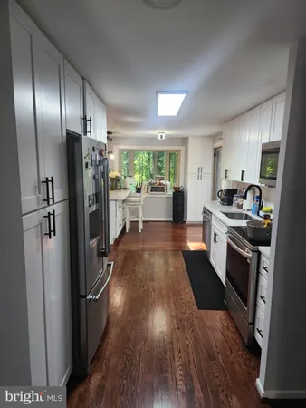 a kitchen with stainless steel appliances a refrigerator and a stove