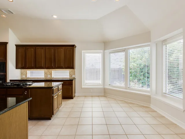 a kitchen with a stove a sink and a microwave
