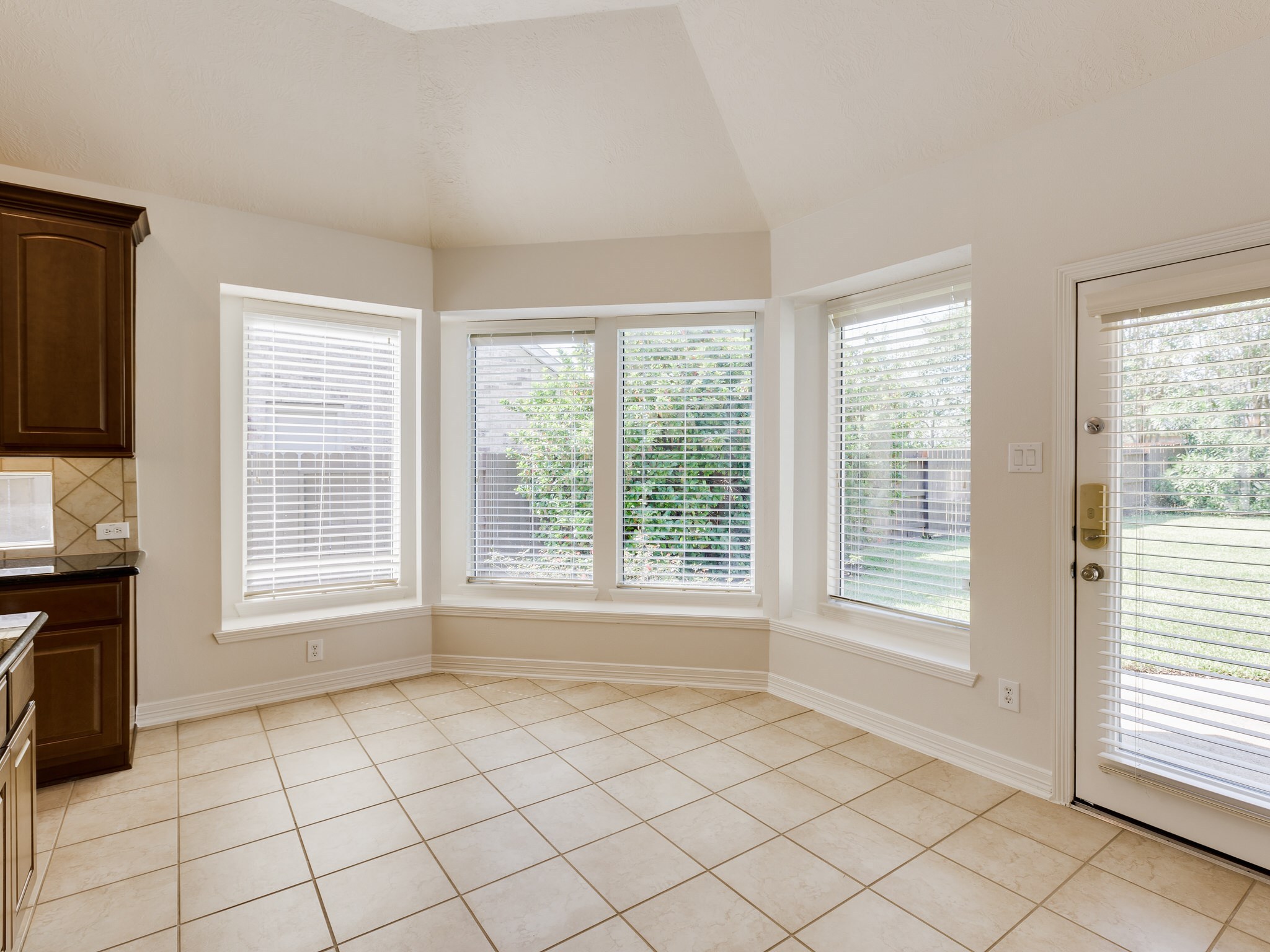 6327 Collina Springs Court Houston, TX 77041 - Photo 13 of 35 a view of an empty room with a window and a kitchen
