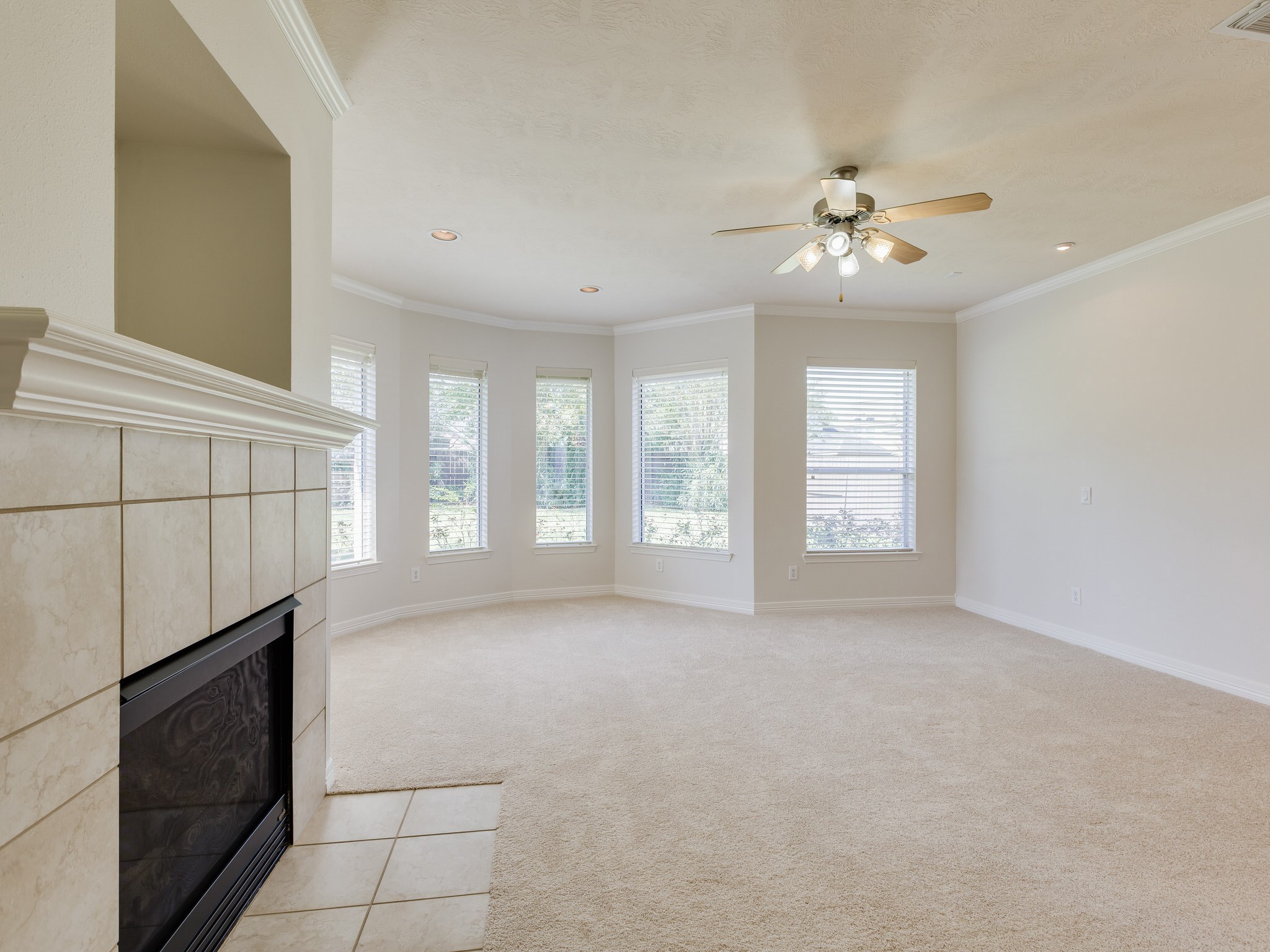 6327 Collina Springs Court Houston, TX 77041 - Photo 14 of 35 a view of an empty room with a fireplace and a window